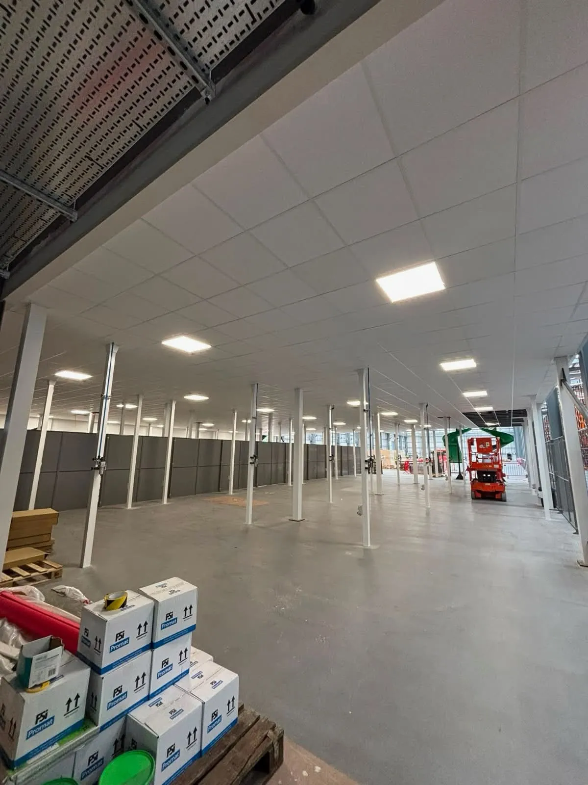 A suspended ceiling and partition walls fitted beneath a mezzanine floor